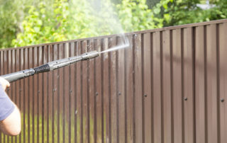 fence maintenance cleaning with pressure power washer